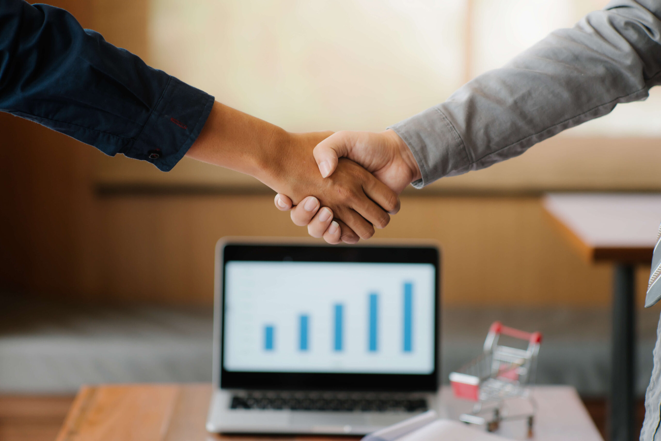 cropped-image-colleagues-shaking-hands-office